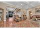 Spacious living room with grand staircase, hardwood floors, and elegant decor at 107 Long Bay Golf Pl., Longs, SC 29568