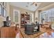 Comfortable home office with hardwood floors, built-in shelving, and natural light at 107 Long Bay Golf Pl., Longs, SC 29568