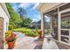 Lovely patio view of a screened-in porch and landscaped yard featuring a fountain and manicured garden at 107 Long Bay Golf Pl., Longs, SC 29568