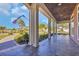 Spacious covered porch with tile flooring, stately columns, and neighborhood views at 107 Long Bay Golf Pl., Longs, SC 29568