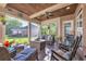 Inviting screened porch with ceiling fan, comfortable seating, and views of the backyard at 107 Long Bay Golf Pl., Longs, SC 29568