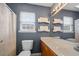 A traditional bathroom is staged with shelves over the toilet and above the vanity with a large mirror at 1117 Jumper Trail Circle, Myrtle Beach, SC 29588