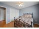 A cozy bedroom with white walls, an iron bed frame, and a double door closet at 1117 Jumper Trail Circle, Myrtle Beach, SC 29588