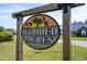 Charming sign for Wooded Acres community with palm tree art welcomes you to the neighborhood at 1117 Jumper Trail Circle, Myrtle Beach, SC 29588