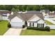 Charming single-story home with lush green lawn, attached two-car garage, and inviting curb appeal at 1117 Jumper Trail Circle, Myrtle Beach, SC 29588