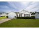 Charming single-story home featuring red shutters and manicured lawn in a desirable neighborhood at 1117 Jumper Trail Circle, Myrtle Beach, SC 29588