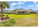 Spacious backyard with a screened patio area, lush lawn, and well-maintained landscaping at 120 Whitemarsh Ct., Murrells Inlet, SC 29576