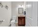 Cozy powder room featuring a dark wood vanity, neutral paint, and decorative mirror at 120 Whitemarsh Ct., Murrells Inlet, SC 29576