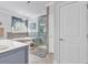 Bright bathroom with a soaking tub, glass shower, and blue vanity at 120 Whitemarsh Ct., Murrells Inlet, SC 29576