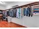 Walk-in closet featuring ample hanging storage with organized clothing and hardwood floors at 120 Whitemarsh Ct., Murrells Inlet, SC 29576