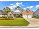 Charming brick home featuring a well-manicured lawn and a two-car garage at 120 Whitemarsh Ct., Murrells Inlet, SC 29576
