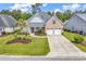 Charming brick home featuring a well-manicured lawn, mature trees, and a spacious driveway at 120 Whitemarsh Ct., Murrells Inlet, SC 29576