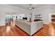 Open-concept living room featuring hardwood floors, a large sectional, and a ceiling fan at 120 Whitemarsh Ct., Murrells Inlet, SC 29576