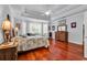 Spacious primary bedroom with hardwood floors, tray ceilings, and abundant natural light at 120 Whitemarsh Ct., Murrells Inlet, SC 29576