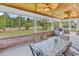 Inviting covered patio with brick accents and a table perfect for outdoor dining at 120 Whitemarsh Ct., Murrells Inlet, SC 29576