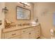 Bright bathroom featuring granite countertops, decorative mirror, and ample storage space at 128 Puffin Dr. # 1-E, Pawleys Island, SC 29585