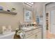 Bright bathroom featuring granite counters, decorative mirror and decor, with access to a bedroom at 128 Puffin Dr. # 1-E, Pawleys Island, SC 29585