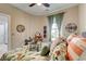 Cozy bedroom features floral bedding, natural light, and vanity at 128 Puffin Dr. # 1-E, Pawleys Island, SC 29585