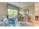 Dining area with wood table and chairs, complemented by natural light and charming decor at 128 Puffin Dr. # 1-E, Pawleys Island, SC 29585