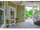 Exterior view with a charming, welcoming entrance adorned with potted plants and a festive wreath at 128 Puffin Dr. # 1-E, Pawleys Island, SC 29585