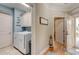 Hallway featuring a laundry room with white washer and dryer, and access to the home's entry and other rooms at 128 Puffin Dr. # 1-E, Pawleys Island, SC 29585