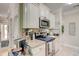 Kitchen with stainless steel appliances, granite countertops, and views into dining area at 128 Puffin Dr. # 1-E, Pawleys Island, SC 29585