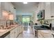 Kitchen showcasing granite countertops, stainless steel appliances, and an open view to the dining area at 128 Puffin Dr. # 1-E, Pawleys Island, SC 29585