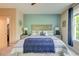 Calming main bedroom features stylish decor, a ceiling fan and closet access at 128 Puffin Dr. # 1-E, Pawleys Island, SC 29585