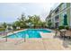Community swimming pool surrounded by lounge chairs and lush landscaping creating a relaxing setting at 128 Puffin Dr. # 1-E, Pawleys Island, SC 29585