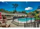 Landscaped backyard with an inground pool, wooden deck, and outdoor furniture at 141 N Gate Rd., Myrtle Beach, SC 29572