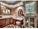 Vanity with sink, makeup table, and a framed mirror in a well-lit bathroom at 141 N Gate Rd., Myrtle Beach, SC 29572