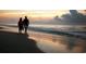 Silhouette of a couple walking on the beach at sunrise, enjoying the serene coastal scenery at 141 N Gate Rd., Myrtle Beach, SC 29572