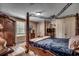 Bedroom featuring a canopy bed, light wood floors, and a large wardrobe at 141 N Gate Rd., Myrtle Beach, SC 29572