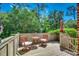 Cozy outdoor deck with seating and privacy fence surrounded by lush greenery at 141 N Gate Rd., Myrtle Beach, SC 29572