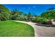 Long, curved driveway leading to a well-maintained brick home surrounded by mature trees at 141 N Gate Rd., Myrtle Beach, SC 29572