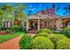 Charming brick home with a lush landscaped yard, brick walkway, front porch, and water fountain at 141 N Gate Rd., Myrtle Beach, SC 29572
