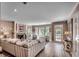 Spacious living room with a fireplace, large windows, hardwood-style flooring, and neutral color scheme at 141 N Gate Rd., Myrtle Beach, SC 29572