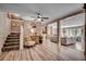 Open living room with hardwood-style floors, staircase, and a view into a second living area with a fireplace at 141 N Gate Rd., Myrtle Beach, SC 29572