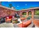 Inviting patio with red brick surround, stone fire pit and comfortable seating area at 141 N Gate Rd., Myrtle Beach, SC 29572