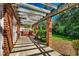 Covered patio featuring brick columns and wooden pergola, with views of backyard at 141 N Gate Rd., Myrtle Beach, SC 29572