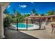 Fenced pool area with a brick pool house, deck, and staircase at 141 N Gate Rd., Myrtle Beach, SC 29572