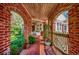Charming porch with brick arches, lush greenery, and comfortable outdoor seating at 141 N Gate Rd., Myrtle Beach, SC 29572