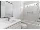 Bright bathroom featuring a white vanity, quartz countertop, and marble tile shower and tub at 1500 Sunmeadow Dr., Conway, SC 29526