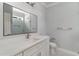 Bathroom with quartz countertops, white cabinets, large mirror, and modern fixtures at 1500 Sunmeadow Dr., Conway, SC 29526
