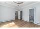 Bright bedroom with wood floors, neutral walls, ceiling fan, and access to ensuite bath at 1500 Sunmeadow Dr., Conway, SC 29526