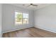 Bedroom with wood-look floors, a ceiling fan, and a large window offering natural light at 1500 Sunmeadow Dr., Conway, SC 29526
