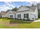 Well-maintained home showcasing white siding, black shutters, and a neatly landscaped yard at 1500 Sunmeadow Dr., Conway, SC 29526