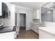 Bright kitchen showcasing white cabinets, stainless steel appliances, and a view into the dining area at 1500 Sunmeadow Dr., Conway, SC 29526