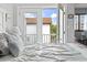 Bedroom with doors leading to an outdoor balcony, offering views of the neighborhood at 1502 Yaupon Dr. # A-1, Myrtle Beach, SC 29577