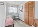 Cozy bedroom features a single bed, window with natural light, and a wooden closet for ample storage at 1502 Yaupon Dr. # A-1, Myrtle Beach, SC 29577